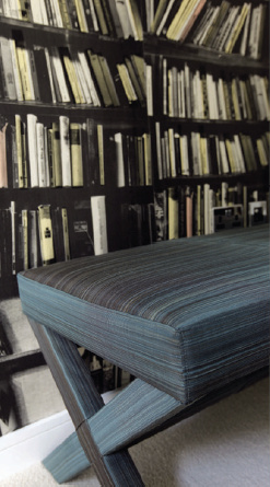 Bookshelves and a blue bench in a quiet interior detail.